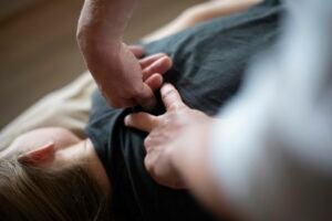 Chiropractor pressing on a patient's back during an adjustment