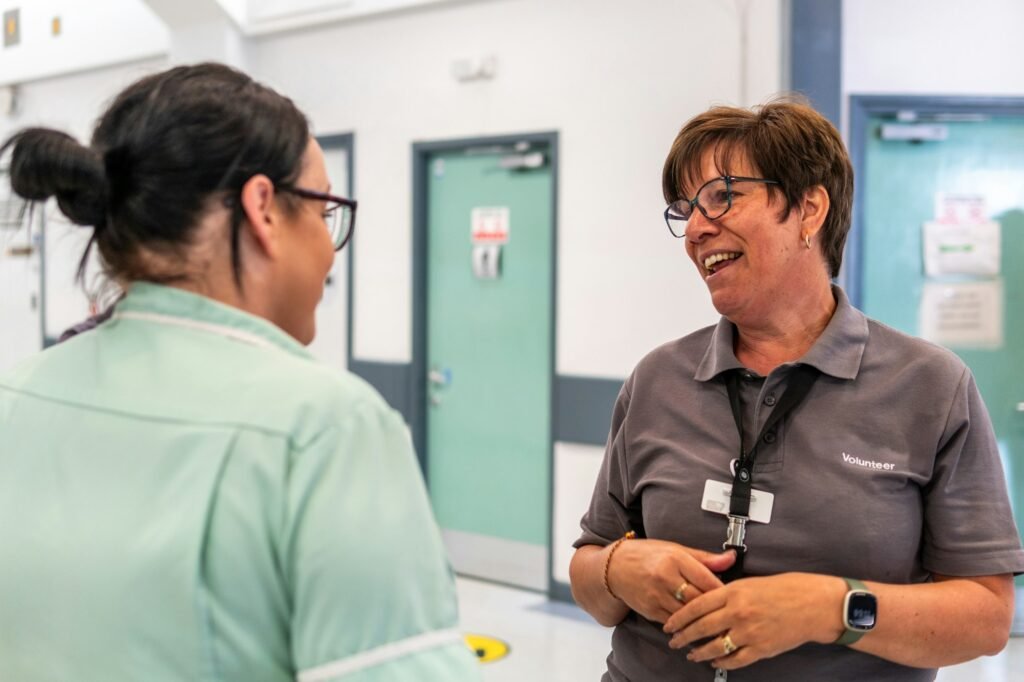 Clinic team members talking, the people payroll services keep paid on time