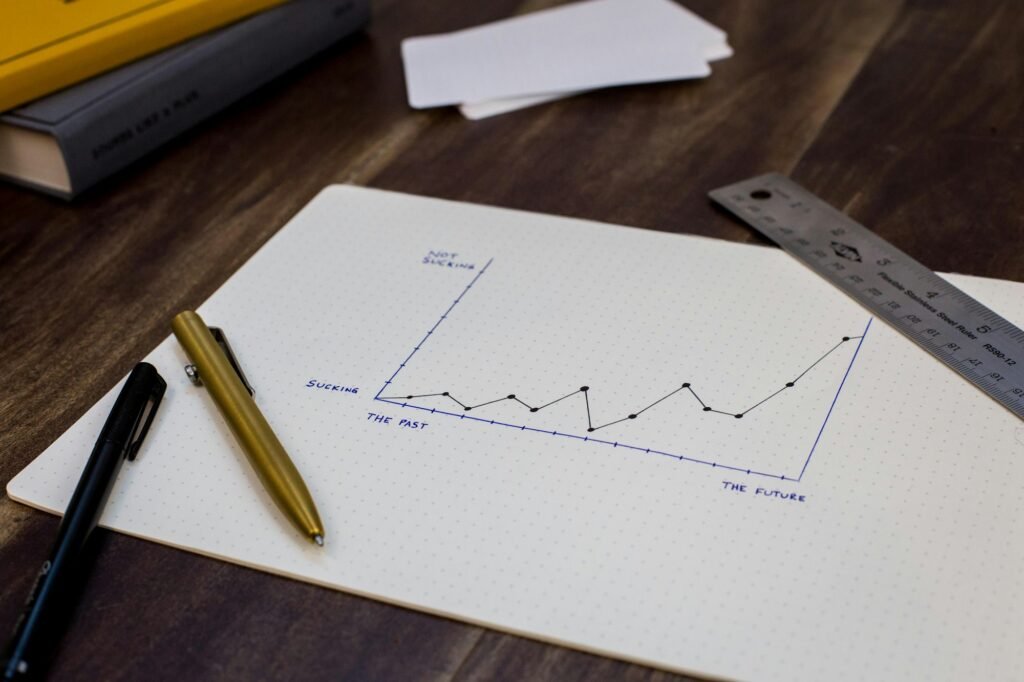 Printed financial report chart with a pen
