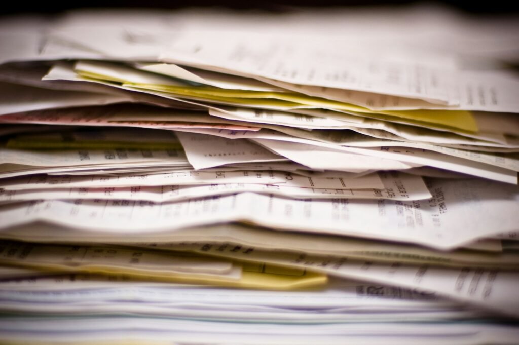 Piles of paperwork before a bookkeeping clean-up