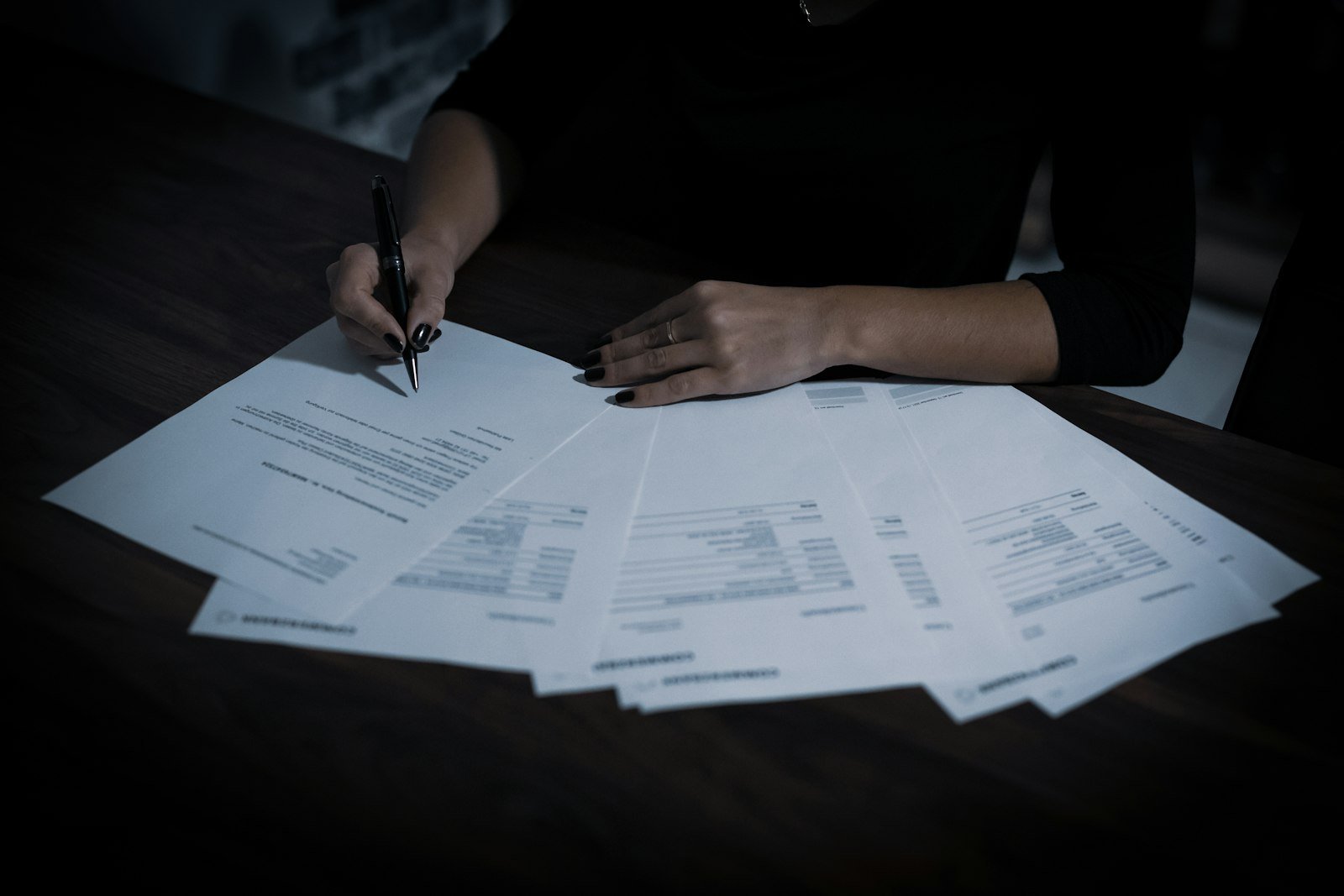 Owner sorting through a table full of paperwork