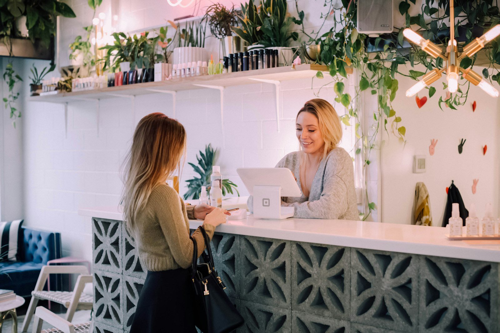 Patient paying by card at a wellness practice front counter