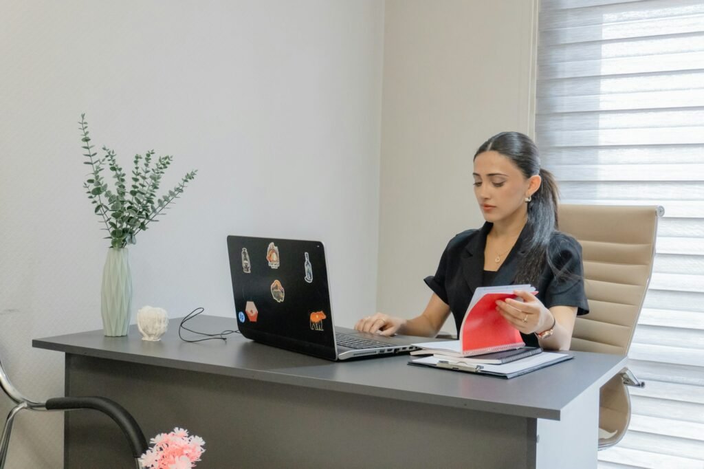 Practice owner working at a laptop at her desk