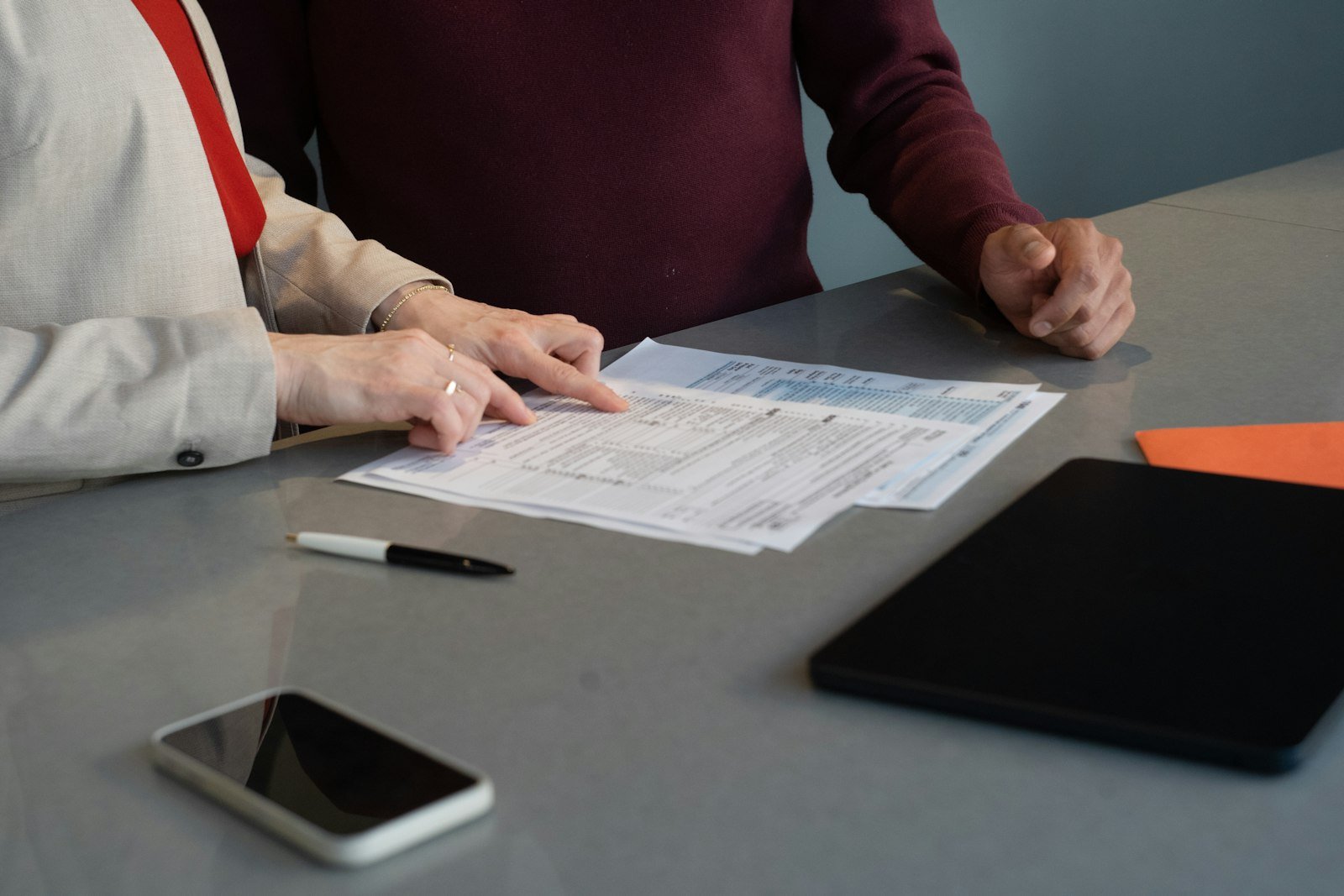 Two people reviewing financial documents together