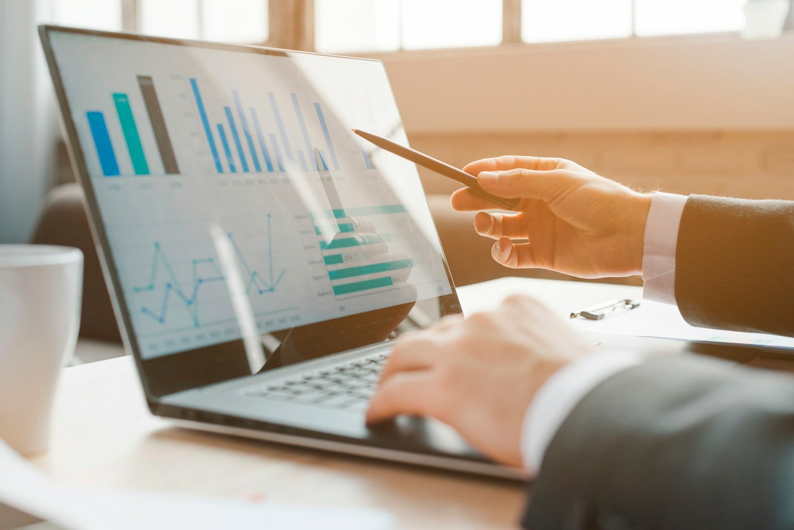 Reviewing financial charts on a laptop